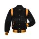 Front view of Black Retro Varsity Jacket featuring a retro collar, black wool body and sleeves, adorned with elegant gold leather shoulder inserts.